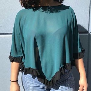 Sheer emerald poncho top with black ruffle trim